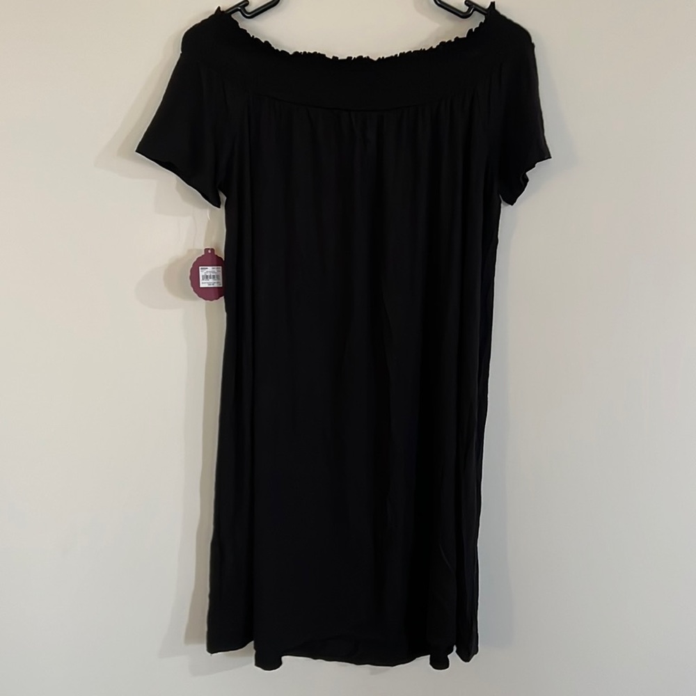 Woman’s off the shoulder black dress